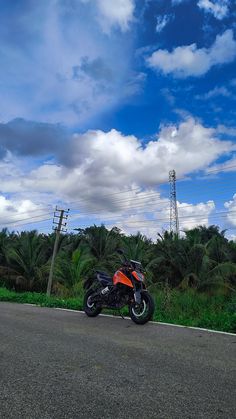 a motorcycle is parked on the side of the road with power lines in the background