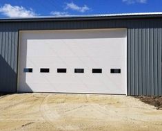 an overhead garage door in front of a metal building