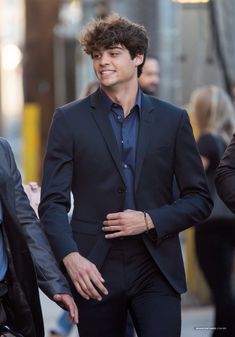 a man in a suit walking down the street