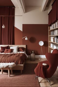 a bedroom with red walls and furniture in the corner, along with bookshelves