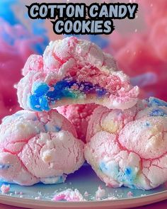 cotton candy cookies on a white plate with pink and blue sprinkles in the background