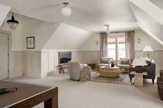 a living room filled with furniture next to a window