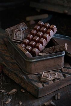 some chocolate bars are in a tin on a table