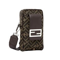 This Fendi Baguette Phone Holder and Crossbody Bags is crafted with a two-tone brown FF logo print canvas. The silver-tone top zipper opens to a black fabric lined interior. It also has a square brown leather flap with the classic FF magnetic snap closure which opens to a front pocket. It also includes a detachable and adjustable crossbody strap. This crossbody is a simpler and smaller bag, making it a great everyday option!        Model Number: 7AS056  Brown Canvas  Iconic Two-Toned Brown FF pr Luxury Brown Baguette Bag For Mobile Phone, Travel Shoulder Bag In Monogram Canvas With Logo Hardware, Brown Coated Canvas Mobile Phone Bag, Monogram Canvas Bag With Logo Hardware For Travel, Rectangular Monogram Canvas Bag With Logo Hardware, Brown Monogram Canvas Bags With Logo Hardware, Brown Monogram Canvas Bag With Logo Hardware, Brown Monogram Canvas Shoulder Bag With Logo Hardware, Brown Monogram Canvas Bag With Zipper Pocket