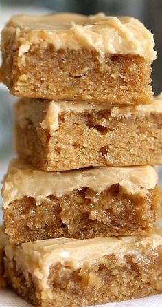 three pieces of peanut butter bars stacked on top of each other with one bite taken out