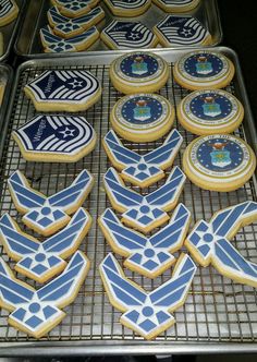 cookies decorated with blue and white designs sit on cooling racks in front of each other