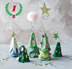 small christmas trees made out of toilet paper and some glitters on the top one