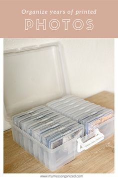 an open plastic box with photos in it on a wooden table and text overlay that reads organize years of printed photos