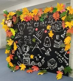 a blackboard with fall leaves and writing on it