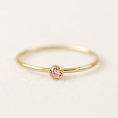 14k gold tiny pink sapphire ring comes in 2mm or 3mm pink sapphire. Please choose your stone size, material, and ring size from the drop-down. This ring is perfect to be stacked or worn alone. The milgrain finish on the setting gives an antique touch to this simple minimalistic ring. Pink sapphire is September birthstone, will make perfect a birthday gift. This ring is also available in white diamond -->http://etsy.me/1GXIB41 * Specifics for 2mm ring: :: Stone size: ≈2mm :: Setting size: ≈4mm Minimalistic Ring, Ivory Ring, Dainty Wedding Ring, Saphir Ring, Layered Rings, Constellation Necklace, Pink Sapphire Ring, Stack Ring, Rose Gold White