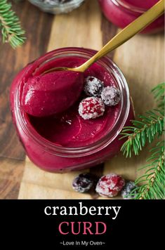 cranberry curd in a jar on a cutting board with berries and pine branches