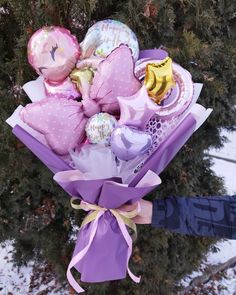 a bouquet of balloons and stuffed animals in the snow