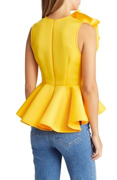 A decadent bloom elevates this vibrant sleeveless blouse punctuated with a frilled peplum. Jewel neck Sleeveless 95% polyester, 5% spandex Dry clean Made in the USA Sleeveless Peplum Top, Satin Camisole, Black Camisole, Pastel Yellow, Jewel Neck, Cami Tanks, Sleeveless Blouse, Crop Tank, Made In The Usa