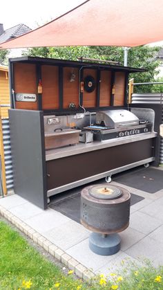 an outdoor bbq with grill and sink in the back