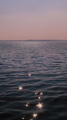 the sun shines brightly on the water as it reflects off the horizon in this photo