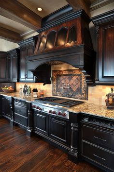 a large kitchen with black cabinets and marble counter tops on the stove top is surrounded by wood flooring