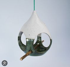 a bird feeder hanging from a green cord