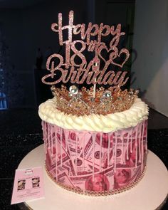 a birthday cake decorated with money and a tiara