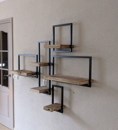 a wall mounted shelf on the side of a building with metal and wood shelves attached to it