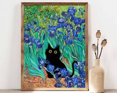 a black cat sitting in front of blue irises on a shelf next to a vase