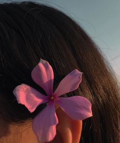 a close up of a person's ear with a flower in the middle of it