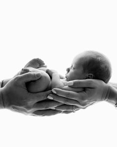 a person holding a baby in their hands