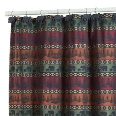 a curtain with an elephant and trees pattern on the top, hanging from a rod