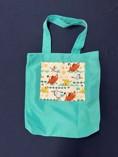 "One of each Tote Bag design is available, featuring various cartoon characters: Lion King, Daniel Tiger, Minnie and Mickey Mouse together on plaid, Bluey, Sonic and others. All totes 100% cotton, except Aqua which is Polyester.  Size: 13.5\" x 13.5\" x 4\" (4\"gusset) Washable in cool or cold water, hang dry or tumble dry low. Iron on low or medium setting.  Details: Minnie Mickey Plaid, 13.5\" x 13.5\" x 4\"  Red tote bag shown in photo. Also available in other colors: Ivory (cream) color tote Multicolor Cartoon Style Bag For Everyday Use, Fun Multicolor Bag With Character Print, Playful Multicolor Bags With Character Print, Playful Multicolor Cartoon Print Bag, Multicolor Character Print Bags For Daily Use, Playful School Bag With Character Print, Playful Character Print Multicolor Bag, Playful Multicolor Character Print Bags, Cartoon Style Multicolor Rectangular Bag