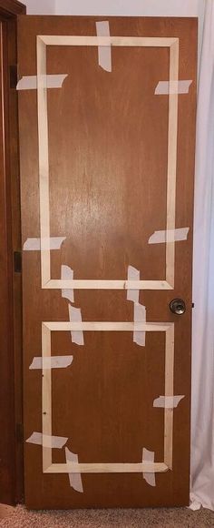 a wooden door with white tape on it