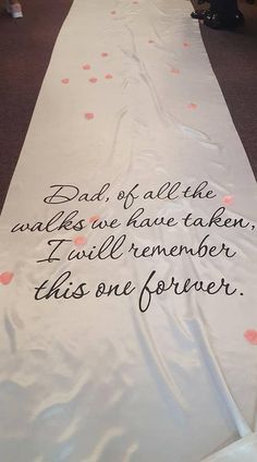 a long white table runner with pink and black confetti on the side that says, dad of all the walks we have taken i will remember this one forever