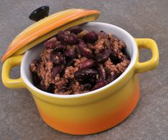 a yellow and orange bowl filled with beans