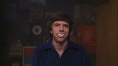 a young man is brushing his teeth in the dark