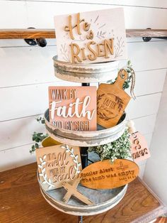 a three tiered cake with wooden signs on it