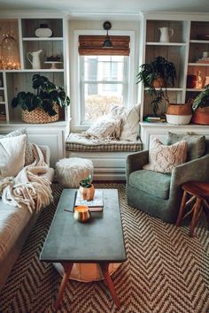 a living room filled with furniture and lots of plants