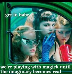 three women in sunglasses are looking out the back window of a green car while holding a drink