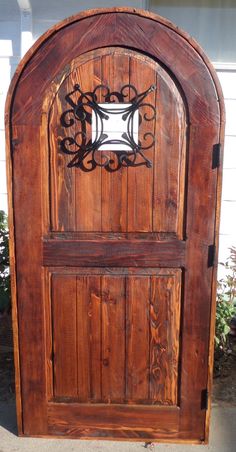 an old wooden door with wrought iron work