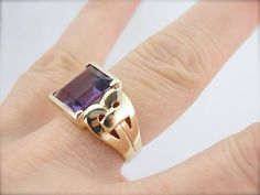 This stunning vintage ring features a luscious Amethyst center, square cut with a lot of glimmer! The simple mounting features beautiful filigree swirl cut-out shoulders that really make this unique and special! Metal: 10K Yellow Gold Gem: Amethyst 4.93 Carats Gem Measurements: 9.9 x 10.6 mm, Rectangle Ring Size: 7.75 Marks: "10K" Stamped on the inside band Elegant Rectangular Amethyst Ring For Formal Occasions, Square Cut Amethyst Ring For Formal Occasions, Formal Square Cut Amethyst Ring, Elegant Amethyst Ring With Rectangular Stone For Formal Occasion, Elegant 14k Gold Rectangular Amethyst Ring, Elegant Formal Amethyst Ring With Rectangular Stone, Formal Purple Amethyst Ring With Rectangular Shape, Formal Rectangular Amethyst Ring, Formal Rectangular Purple Amethyst Ring