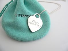 Looking for a perfect Anniversary gift? Here it is! Offered for sale is a very pretty Tiffany & Co. Silver "Happy Anniversary" Heart charm necklace. Hanging from its bright Tiffany sterling silver curb chain is a wonderful heart charm with the words "Happy Anniversary" written in beautiful script form. The heart charm is currently unengraved on the back so it is ready to be personalize if you chose to do so. The necklace is simple, elegant, and classic all rolled into one item. It is a wonde Heart Charm Necklace, Charm Chain, Happy Words, Simple Elegant, Tiffany Heart, Curb Chain, Happy Anniversary, Heart Charm Bracelet, Silver Heart