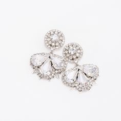 Our LEXES earrings are absolutely gorgeous and timeless to wear for a classic look. The silhouette consists of a a bigger floral design filled with crystals shaped in a leaf form to add a fine look. These will add a touch of sparkle to a stylish look. Handcrafted Highest Quality Swarovski / Cubic Zirconia Platinum plated Guards against scratches and tarnish. approximate size 1.15" length 1" width Nickel free Free Shipping in USA Elegant Crystal Flower Earrings For Party, Elegant Crystal Clip-on Earrings, Sparkling Stones Drop Earrings For Wedding, Elegant Sparkling Flower Drop Earrings, Wedding Flower Drop Earrings With Sparkling Stones, Elegant Crystal Teardrop Earrings With Rhinestones, Elegant Teardrop Crystal Embellished Earrings, Elegant Cubic Zirconia Flower-shaped Crystal Earrings, Elegant Crystal Flower Shaped Earrings