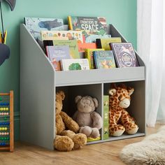 a book shelf with stuffed animals and books on it in a child's room