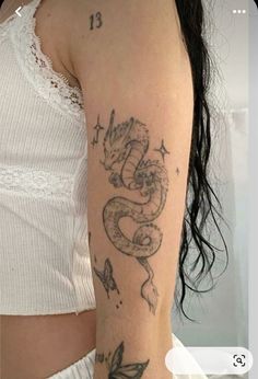 a woman with a dragon tattoo on her arm