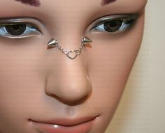 a mannequin's face with piercings on it