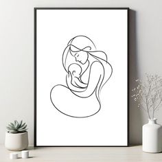 a black and white drawing of a woman holding a baby in her arms on a shelf