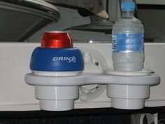 two water bottles are attached to the side of a boat's front end mirror