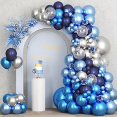 blue and silver balloons are in front of an arch