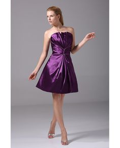 a woman in a purple dress posing for the camera