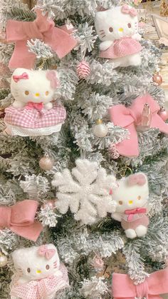 a christmas tree with hello kitty ornaments on it