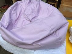 a purple bean bag sitting on top of a yellow table