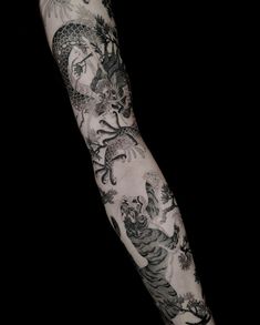 a man's arm with tattoos on it