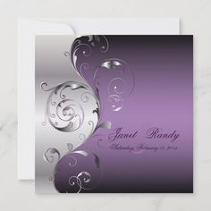 an elegant purple and silver wedding card with swirls on the front, in white